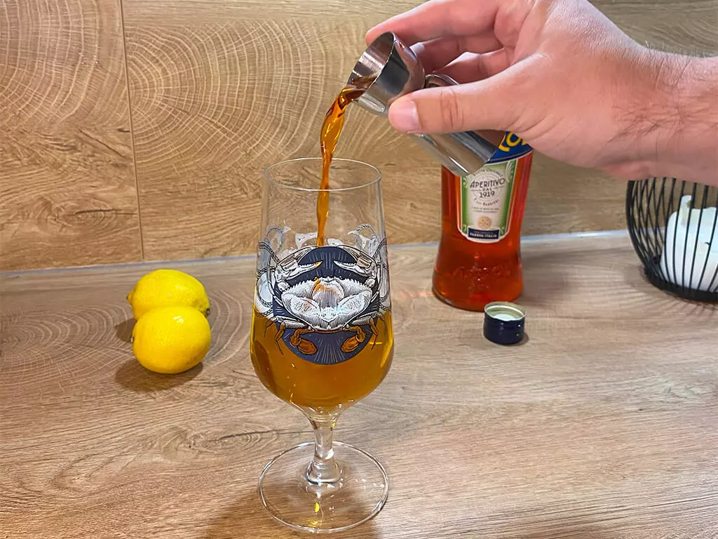 3 cl Aperol werden in ein Bierglas mit Flensburger Edles Helles geschüttet.