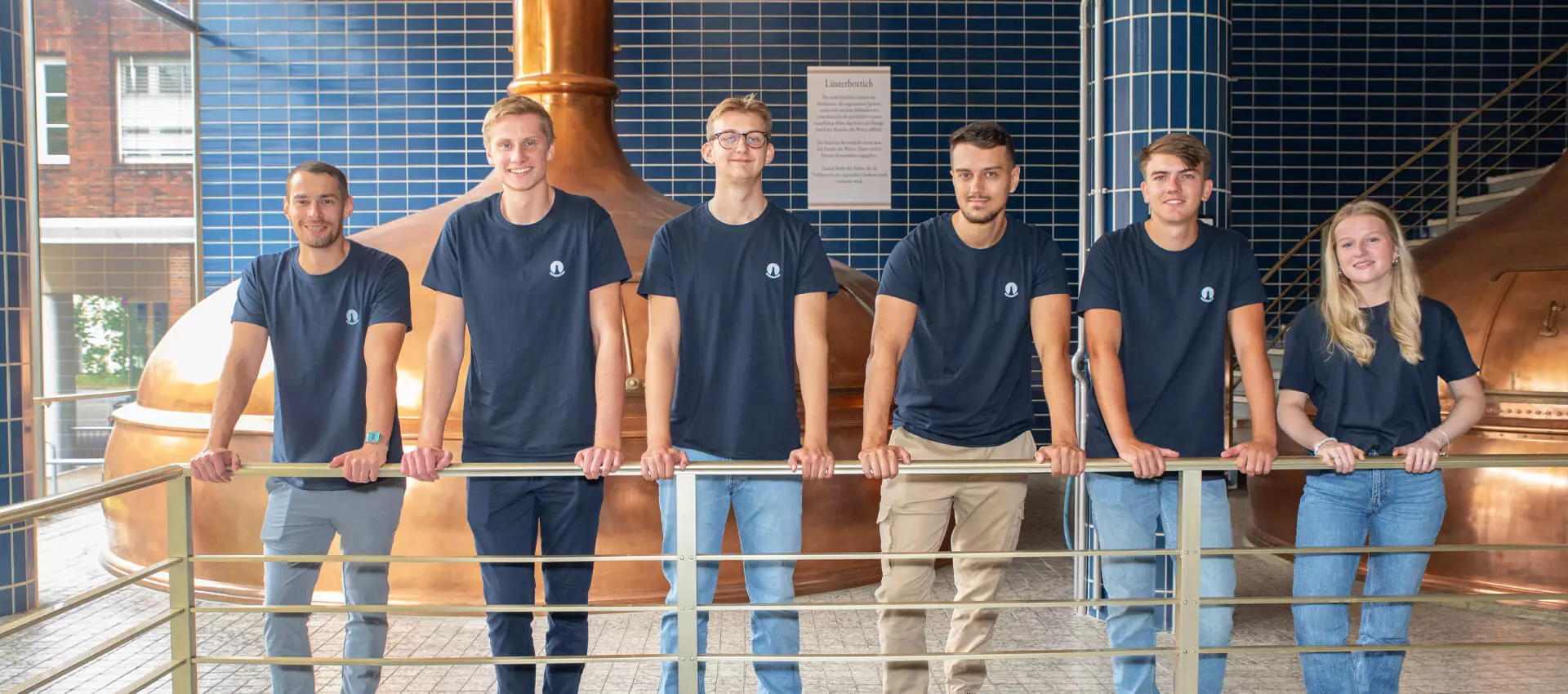 Die sechs neuen Azubis der Flensburger Brauerei aus 2024 im Sudhaus.